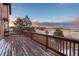 This spacious deck provides an outdoor area with a serene landscape as the sun begins to set at 47032 Frasier Fir Cir, Parker, CO 80138