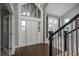 Bright foyer featuring a soaring ceiling, a grand staircase, and elegant entry door at 47032 Frasier Fir Cir, Parker, CO 80138