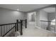 Hallway with black metal railing offers views to adjacent rooms and staircase at 47032 Frasier Fir Cir, Parker, CO 80138