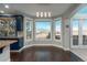 Inviting kitchen nook has views of the lush exterior, pendant lighting, and hardwood floors at 47032 Frasier Fir Cir, Parker, CO 80138