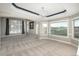 Spacious living room features many windows for natural light, complemented by tray ceiling and elegant chandelier at 47032 Frasier Fir Cir, Parker, CO 80138