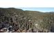Stunning aerial view showcasing the home surrounded by a lush forest at 11953 Us Highway 285, Conifer, CO 80433