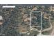 Aerial view of the property highlighting lot lines, home location and surrounding trees at 11953 Us Highway 285, Conifer, CO 80433