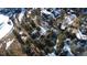 An aerial view of a mountain home surrounded by trees and snow on a partly cloudy day at 11953 Us Highway 285, Conifer, CO 80433