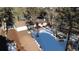 Ranch style home with a detached garage and driveway, nestled in a snowy wooded area at 11953 Us Highway 285, Conifer, CO 80433