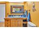 Unique bathroom with blue tile, wood vanity, and a mirror at 11953 Us Highway 285, Conifer, CO 80433