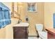 A bathroom with a toilet, sink, mirror, and a dark wood vanity at 11953 Us Highway 285, Conifer, CO 80433