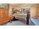 Bedroom with a four poster bed, wood furnishings, and a sliding glass door to the backyard at 11953 Us Highway 285, Conifer, CO 80433