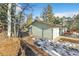 Green house exterior with a detached garage and snowy landscape at 11953 Us Highway 285, Conifer, CO 80433