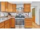 Traditional kitchen features wood cabinets, tile backsplash, and stainless steel appliances at 11953 Us Highway 285, Conifer, CO 80433