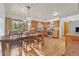 Eat-in kitchen with wood cabinets, stainless appliances, and a sun-filled dining area at 11953 Us Highway 285, Conifer, CO 80433