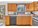 Traditional kitchen features wood cabinets, black dishwasher, and stainless steel oven at 11953 Us Highway 285, Conifer, CO 80433