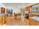 Bright kitchen featuring wood cabinetry and an adjacent dining area with backyard views at 11953 Us Highway 285, Conifer, CO 80433