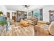 Inviting living room with a stone fireplace, wood floors, and neutral-colored sofas at 11953 Us Highway 285, Conifer, CO 80433