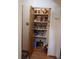 Organized pantry with shelving stocked with various food items and storage containers, optimizing kitchen space at 11953 Us Highway 285, Conifer, CO 80433