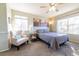 Second bedroom with a queen bed, window, and ceiling fan at 1214 S Zeno Way # D, Aurora, CO 80017