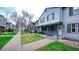 Charming townhouse with well-maintained front yard and welcoming covered porch at 677 Vrain St # 15, Denver, CO 80204