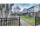 View of a row of townhomes with well-maintained lawns, sidewalks, and mature trees in a community at 677 Vrain St # 15, Denver, CO 80204