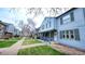 Charming two-story home with a covered porch, manicured lawn, and mature trees at 677 Vrain St # 15, Denver, CO 80204