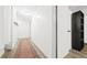 Long hallway featuring wood flooring, a patterned rug, and access to multiple rooms in the home at 677 Vrain St # 15, Denver, CO 80204