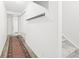 Hallway with floating shelf and access to stairway, showcasing modern design and practicality at 677 Vrain St # 15, Denver, CO 80204