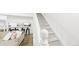 Bright living space with open floor plan, modern bar seating, and a staircase leading to the upper level at 677 Vrain St # 15, Denver, CO 80204