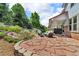Outdoor patio area featuring stone tile, comfortable seating, and a built-in barbecue for relaxed outdoor living at 10683 Amesbury Way, Highlands Ranch, CO 80126