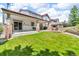 A spacious backyard with a covered patio and well-maintained lawn offers an inviting outdoor retreat at 10683 Amesbury Way, Highlands Ranch, CO 80126