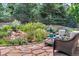 A serene backyard oasis with a patio and lush landscaping, ideal for relaxation at 10683 Amesbury Way, Highlands Ranch, CO 80126