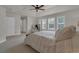 Spacious bedroom featuring a ceiling fan, windows with shutters, and neutral carpeting at 10683 Amesbury Way, Highlands Ranch, CO 80126