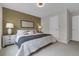 Cozy bedroom featuring a bed, bedside lamps, and neutral color scheme at 10683 Amesbury Way, Highlands Ranch, CO 80126