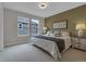 Well-lit bedroom featuring a bed, two windows, and light and airy decor at 10683 Amesbury Way, Highlands Ranch, CO 80126