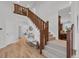 Elegant foyer with hardwood floors, staircase, and an open floor plan with view to the kitchen at 10683 Amesbury Way, Highlands Ranch, CO 80126