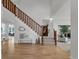 Bright foyer with hardwood floors, a staircase, and an open view to other living spaces at 10683 Amesbury Way, Highlands Ranch, CO 80126