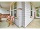 Inviting front porch featuring a seating area, ample windows, and brick accents at 10683 Amesbury Way, Highlands Ranch, CO 80126