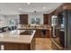 Modern kitchen featuring a large island, stainless steel appliances, granite countertops, and wood flooring at 10683 Amesbury Way, Highlands Ranch, CO 80126