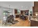 Open kitchen with dark wood cabinetry, an island with bar seating, and hardwood floors at 10683 Amesbury Way, Highlands Ranch, CO 80126