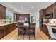 Gourmet kitchen with dark cabinets, granite countertops, stainless steel appliances, and an island at 10683 Amesbury Way, Highlands Ranch, CO 80126