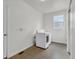 A well-lit laundry room with a modern white washer and dryer set for convenient chores at 10683 Amesbury Way, Highlands Ranch, CO 80126