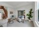 Bright living room featuring ample seating, large windows, and neutral decor at 10683 Amesbury Way, Highlands Ranch, CO 80126