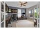 Home office featuring custom built-ins, a ceiling fan, and natural light at 10683 Amesbury Way, Highlands Ranch, CO 80126