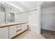 Bathroom features double sinks, a tiled floor, and a shower and tub combination behind a shower curtain at 2824 W Centennial Dr # L, Littleton, CO 80123