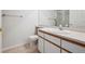 Bathroom features a tile floor, a toilet, a vanity with sink, and a walk-in shower with glass doors at 2824 W Centennial Dr # L, Littleton, CO 80123
