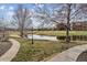 Scenic community view with pond, golf course, and mature trees at 2824 W Centennial Dr # L, Littleton, CO 80123