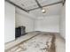 A spacious garage features a dirty floor, access door, lighting and an automatic door opener at 2824 W Centennial Dr # L, Littleton, CO 80123