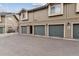 Townhome garage with multiple gray doors and clean exterior at 2824 W Centennial Dr # L, Littleton, CO 80123