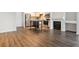 Open living area featuring wood floors, a kitchen island, and a fireplace at 2824 W Centennial Dr # L, Littleton, CO 80123