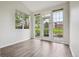 Bright living room featuring wood floors and large windows with outside views at 2824 W Centennial Dr # L, Littleton, CO 80123