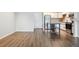 Open living area featuring wood floors, a kitchen island, and stainless appliances at 2824 W Centennial Dr # L, Littleton, CO 80123