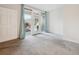 Living room with neutral carpet, white walls, and a glass door that opens to an outdoor space at 2824 W Centennial Dr # L, Littleton, CO 80123